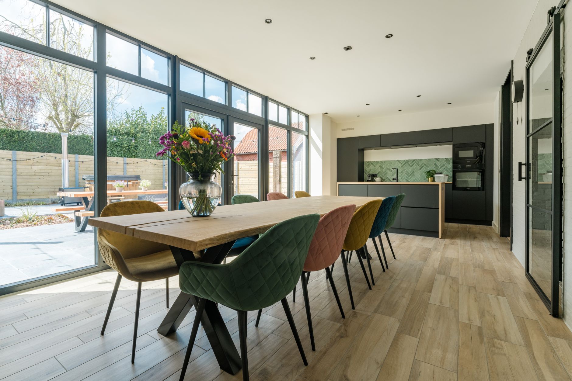 Eetkamer met lange tafel op een lichte vloer